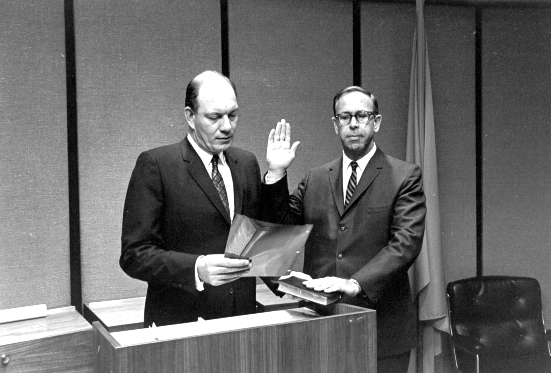Photograph of FHWA Administrator Lowell K. Bridwell being sworn in by  Secretary of Transportation Alan S. Boyd.</p>