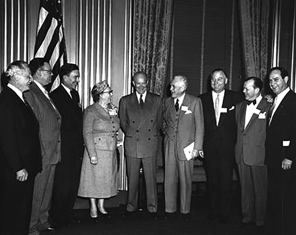 In the Oval Office at the White House, President Eisenhower announced creation of an Action Committee on Traffic Safety on April 13, 1954. Standing next to the President are Mrs. Raymond Sayre of Iowa, the woman's representative, and Harlow H. Curtice, president of General Motors Corporation and chair of the committee.