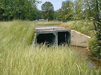 Photograph. A pair of square concrete culverts is shown.