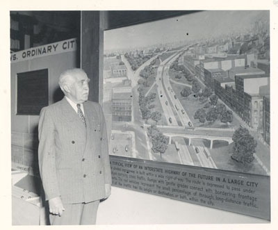General Philip B. Fleming, Administrator of the Federal Works Agency, home of the Public Roads Administration (PRA), views PRA exhibit at the 1948 convention of the American Road Builders Association in Chicago.