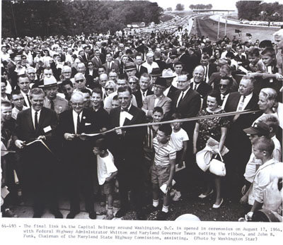 Capital Beltway - Maryland - The final link in the Capital Beltway around Washington, D.C. is opened in ceremonies on August 17, 1964, with Federal Highway Administrator Rex Whitton and Maryland Governor Millard Tawes cutting the ribbon, and John B. Funk, Chairman of the Maryland State Highway Commission, assisting.  (Photo by Washington Star)