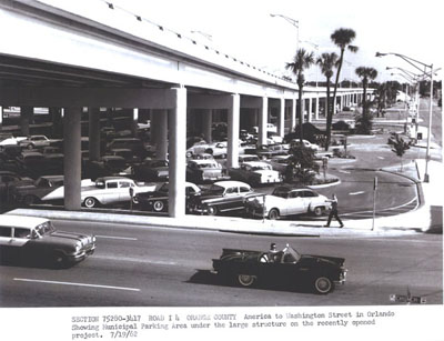 Florida - I-4 (Section 75280-3417) in Orange County - America to Washington Street in Orlando showing Municipal Parking Area under the large structure on the recently opened project. 7-19-62.