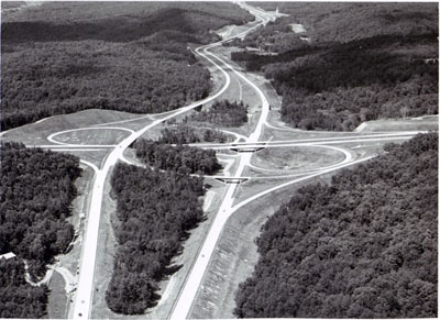 Georgia - The interchange between Interstate Route 285 (Bottom- Top) and Interstate 75 (Right - Left) northwest of Atlanta, Illustrates the beauty achieved through varying roadway elevations and median width and selective clearing in the original design and construction of a highway.