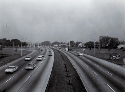 Interstate 94 (Edens Expressway) showing 6 traffic lanes, off ramp right and one ramp left, steel cable guard in median, Chicago, Illinois.