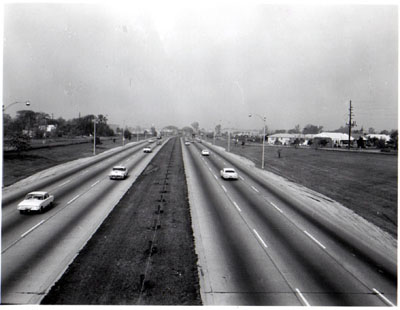 Interstate 94 (Edens Expressway) View showing 6 traffic lanes, crushed stone shoulders, and steal cable guardrail in median.  Looking north from Carpenter Road.  Chicago, Illinois.