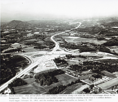 North Carolina - This aerial photo was taken looking northwest along I-26 with the U.S. 64 interchange shown in the foreground.  This project was handled under two contracts totaling more than $5.5 million.  Work began February 25, 1963, and the roadway was opened to traffic on January 9, 1967.