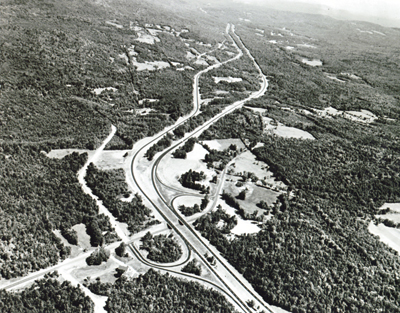 New Hampshire- Interstate Route 93 near Sanbornton, illustrates the use of independent roadway design and the preservation of trees on the roadside and in the median, for scenic effect and economy.