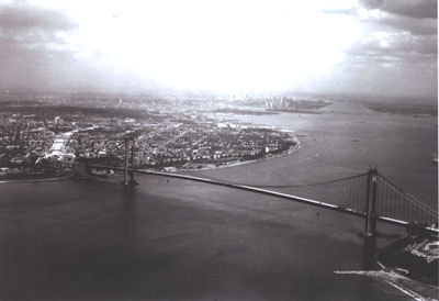 New York - Verrazano-Narrows Bridge between New York City and Staten Island is the largest suspension bridge in the world.  Total length of bridge is 13,700 feet; length of suspended structure, 6,690 ft; main span, 4,260 ft; each side span, 1,215 ft; width 103 feet.  The main towers reach 690 feet above the mean high water and the clearance at center is 228 feet above the mean high water.  On two decks with roadways of 74 feet