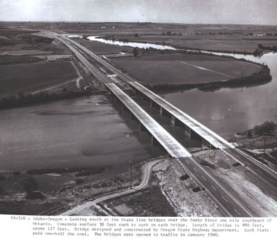 Idaho-Oregon - Looking south at the State line bridges over the Snake River one mile southeast of Ontario.  Concrete surface, 30 foot curb on each bridge.  Length of bridge is 986 feet, spans 127 feet.  Bridge designed and constructed by Oregon State Highway Department.  Each State paid one-half the cost.  The bridges were opened to traffic in January 1960