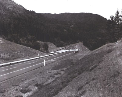 Oregon - Interstate Route 80N (now I-84) travels rough country along the Columbia River near Cascade Locks.  A narrow median with safety guard rail was used, since a broad median would have been too costly.