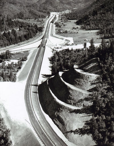 Oregon- The North Wolf Creek Interchange, looking north, on I-5 serves the town of Wolf Creek just out of the photograph on the left.  The slopes are stabilized by the benching technique, which also catches falling rocks.