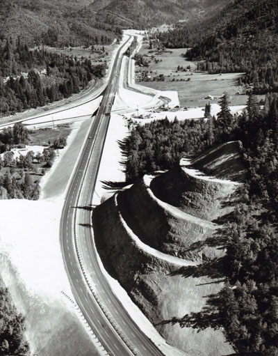 Oregon- The North Wolf Creek Interchange, looking north, on I-5 serves the town of Wolf Creek just out of the photograph on the left.  The slopes are stabilized by the benching technique, which also catches falling rocks.