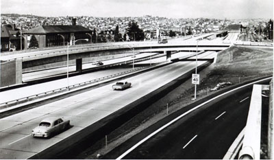 Washington- The reversible center roadway (not yet in use)  of the Seattle Freeway, part of Interstate 5, will meet the alternating-direction peak demand of morning and evening rush-hour traffic.