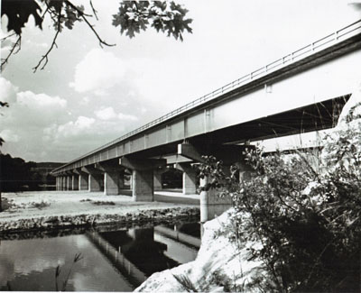 These to pairs of twin bridges on Interstate Route 90 in Wisconsin Illustrate both the functional grace and the diversity of design with which bridge builders fit structures to location needs.  The girder bridges supported on piers cross the Wisconsin River; the steel arches span Mirror Lake near the Wisconsin Dells. These bridges are part of a 55-mile, $32 million section of Interstate 90 between Madison and the Dells, opened to traffic in October 1961.