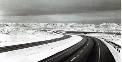 Interstate Route 90 traverses the snow-clad hill of northern Wyoming between Buffalo and Gillette.