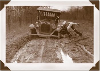 Antique car stuck in mud.