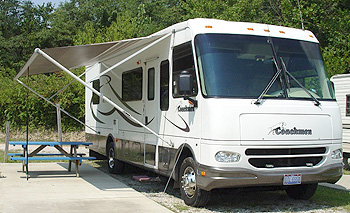 Photo of a recreation vehicle with its awning open.