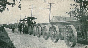 Tractor hauling crushed stone cars.