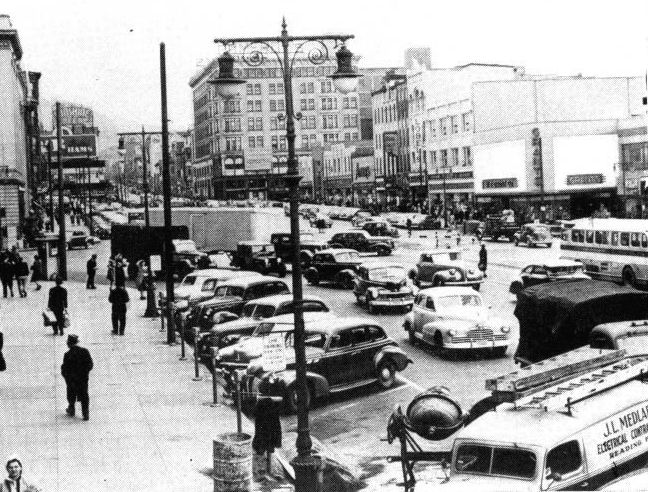 The street is U.S. Route 422 in Reading, Pa. Its extreme width is negated by the lack of channelization or control, as evidenced by the haphazard, crowded vehicular movements.