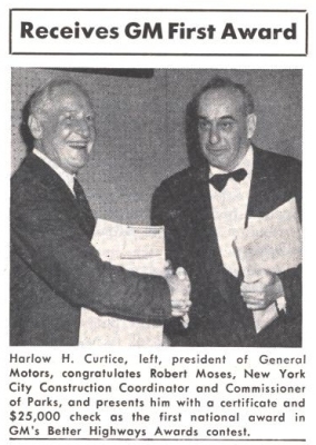 Harlow H. Curtice left, president of General Motors, congratulates Robert Moses, New York City construction Coordinator and Commissioner of Parks, and presents him with a certificate and $25,000 check as the first national award in GM's Better Highways Awards contest.