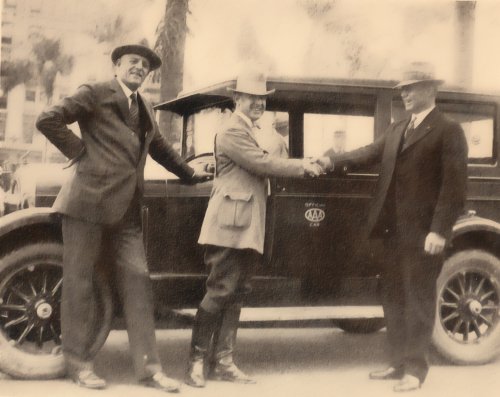 Major Bernard S. McMahan (center) arrives in San Diego on November 30 and is greeted by Mayor John L Bacon (right) and Colonel Ed Fletcher, Vice President of Lee Highway Association.