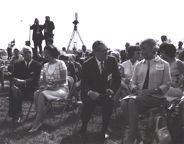 At the Dumfries Wayside Shelter on I-95, photographers on a platform record events as Lady Bird Johnson talks with Virginia Governor Albertis Harrison while Federal Highway Administrator Rex Whitton chats with Muriel Humphrey, wife of Vice President Hubert H. Humphrey.