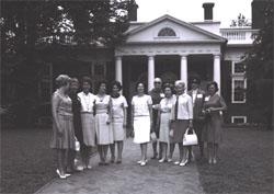 Posing before Monticello, home of Thomas Jefferson.  Identified participants are Mary Connor (third from left), wife of Secretary of Commerce John T. Connor; Lady Bird Johnson (center), still holding her color camera; Trudye Fowler, wife of Secretary of the Treasury Henry T. Fowler; and Muriel Humphrey (third from right), wife of Vice President Hubert H. Humphrey.