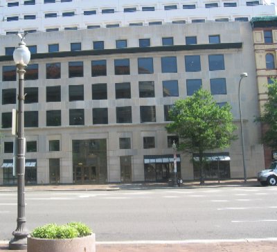 The old shops on the north side of Pennsylvania Avenue, including the "Ladies Shoe Shop" that was going out of business in 1989, have been replaced by a modern office building with shops lining the street.