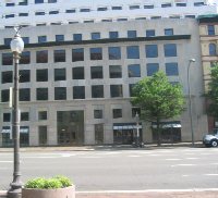 The old shops on the north side of Pennsylvania Avenue, including the "Ladies Shoe Shop" that was going out of business in 1989, have been replaced by a modern office building with shops lining the street.