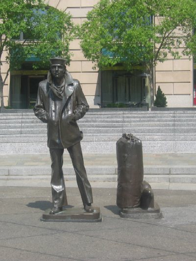This life-size statue of a young sailor is part of the U.S. Navy Memorial on the north side of Pennsylvania Avenue between 7th and 9th Streets.  The waterfall that lines the memorial was not in operation on the day this photograph was taken.