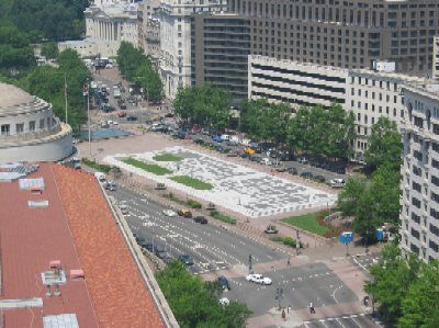 This photo, taken from the Bell Tower at the Old Post Office Building, shows Freedom Plaza along Pennsylvania Avenue.  The United States Treasury is seen at the top of the photo.  On the left, the circular structure sits atop the Ronald Reagan Building and International Trade Center.