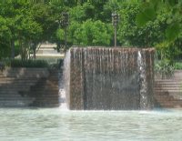 At Pershing Park, this pool and waterfall attract visitors to relax.