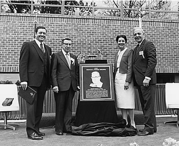 4 people pose with plaque. Left to right: Deputy Administrator Lester P. Lamm, former Administrator Frank Turner, Secretary of Transportation Elizabeth Dole, and Administrator Ray A. Barnhart.