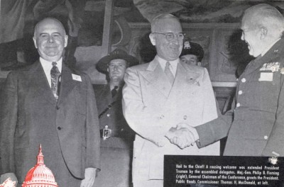 At the 1947 Highway Safety Conference, an honor guard of State police offers stood behind President Truman (center) while he spoke.  General Fleming (right) and Commissioner of Public Roads Thomas H. MacDonald greeted the President on stage