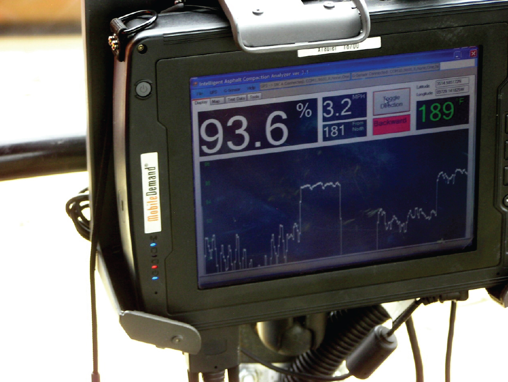 The photo depicts the computer display of the Intelligent Compaction Analyzer (IACA). The IACA estimates the density of asphalt pavement in real time so workers can detect and fix compaction problems during the paving process, saving time and money. The components consist of a GPS receiver and an embedded computer/display which mounts on the vibratory compactor.