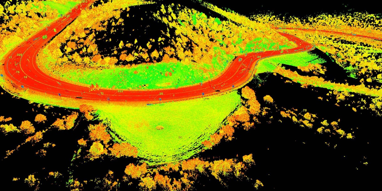 LiDAR image of a roadway from a drone, showing bright colors for different topography.
