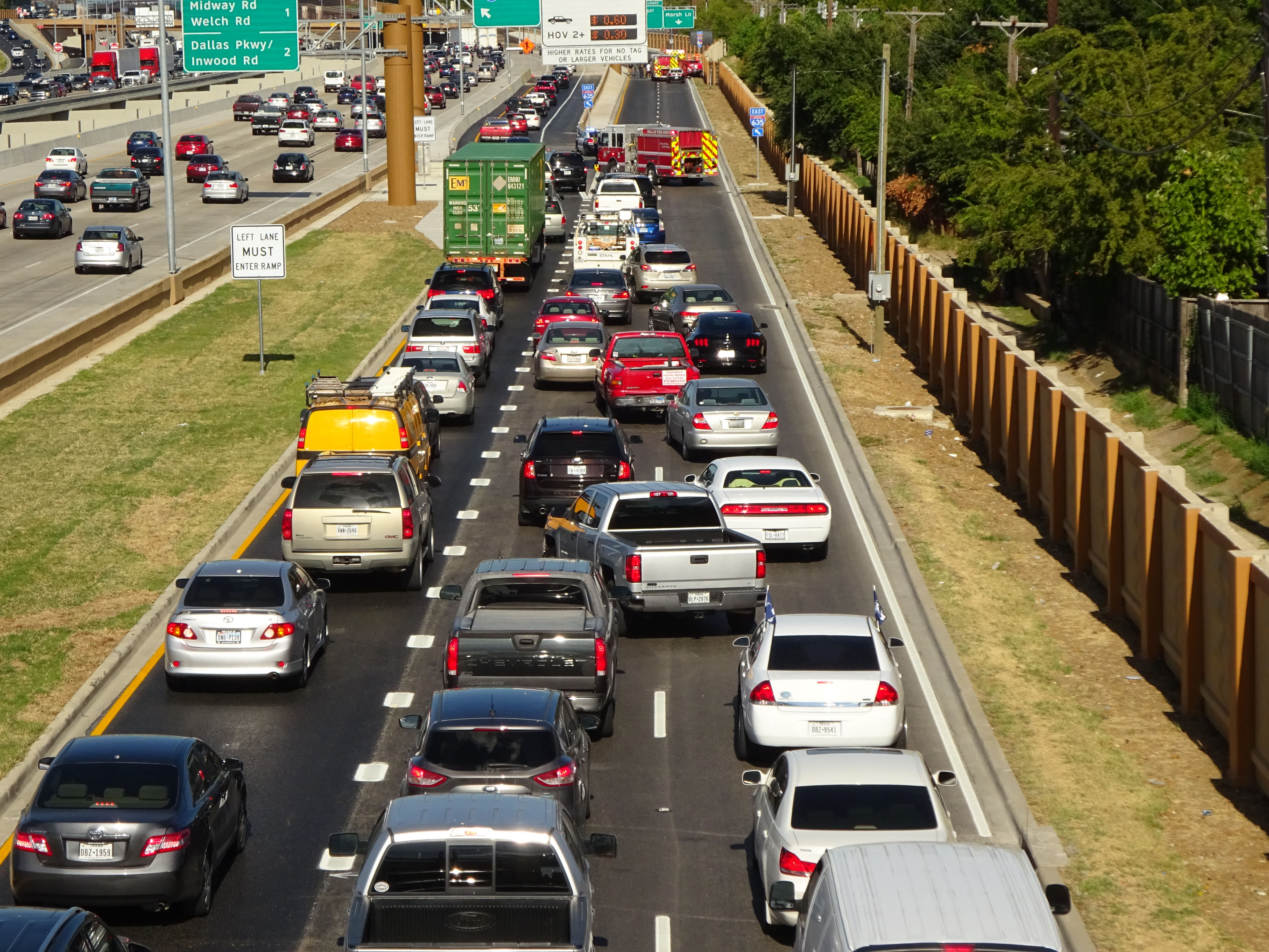 A traffic jam on a three-lane six-lane divided highway.