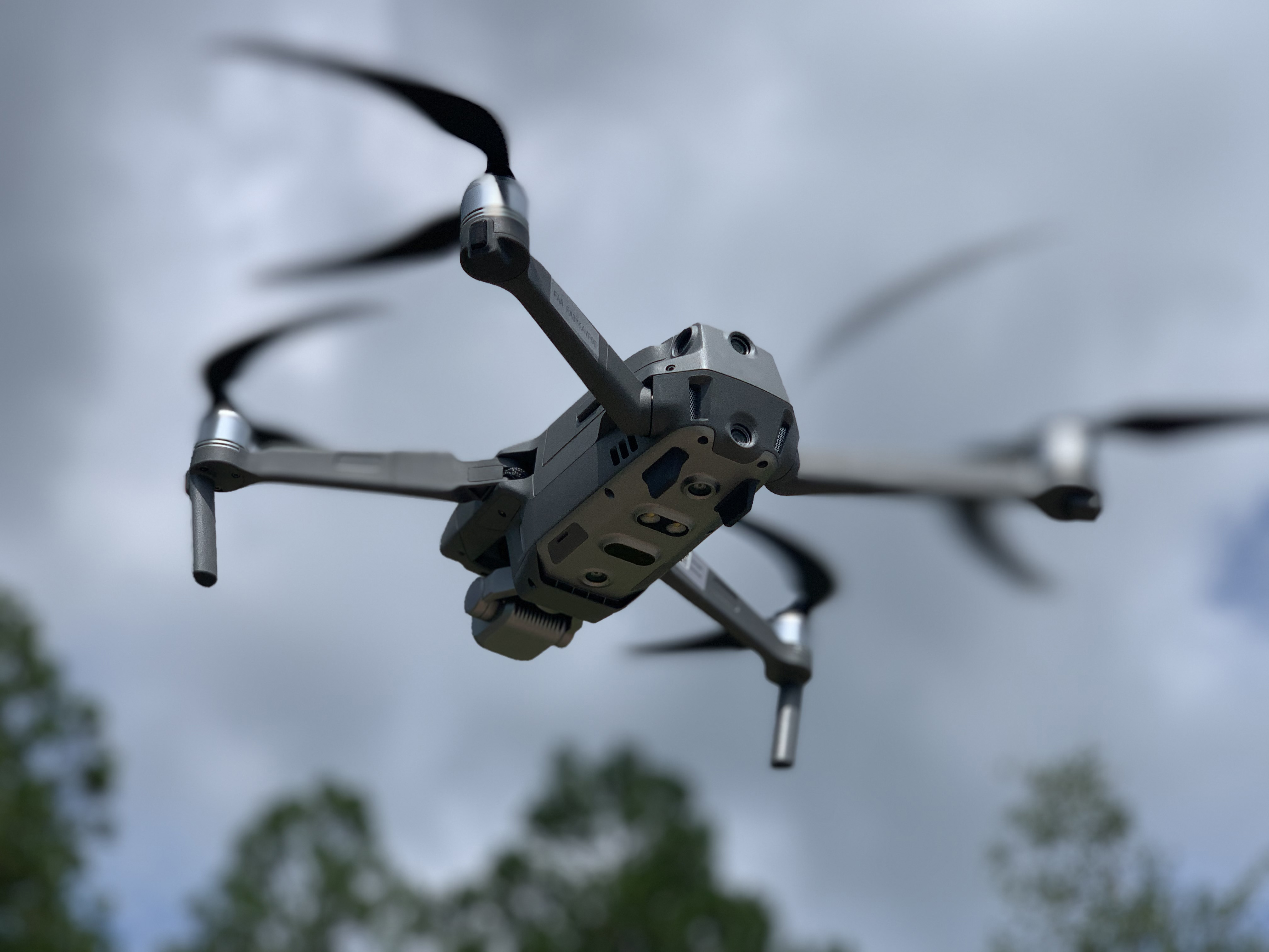 Close up photo of an unmanned aerial system flying in midair.