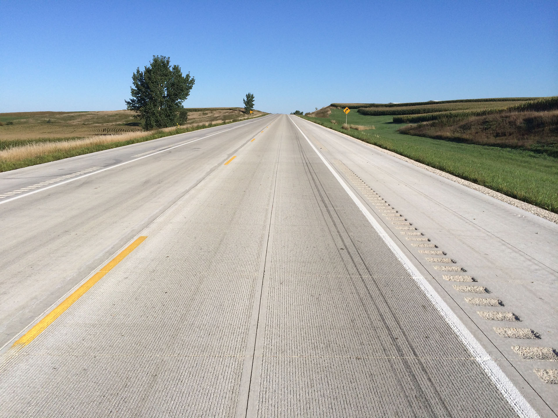 Photo of a two-lane rural concrete highway with no traffic.