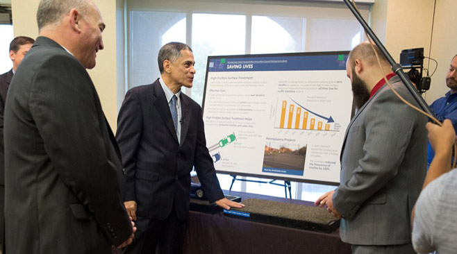 Photo: Gregory Nadeau (left) and Victor Mendez (center) view exhibits at the Pennsylvania Innovation Showcase in Harrisburg. Credit: Pennsylvania Department of Transportation
