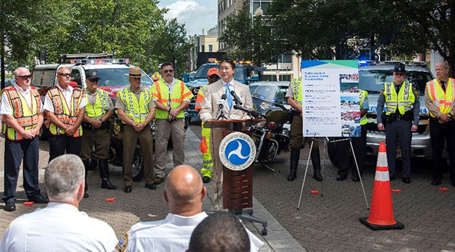 Deputy Federal Highway Administrator David Kim leads an August 10 ceremony marking the training of 200,000 first responders in traffic incident management.