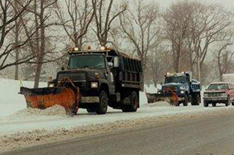 Photo of trucks plowing snow