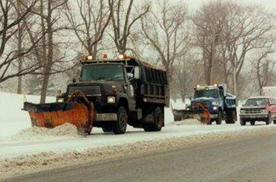Photo of snowy roads and snow clearing trucks