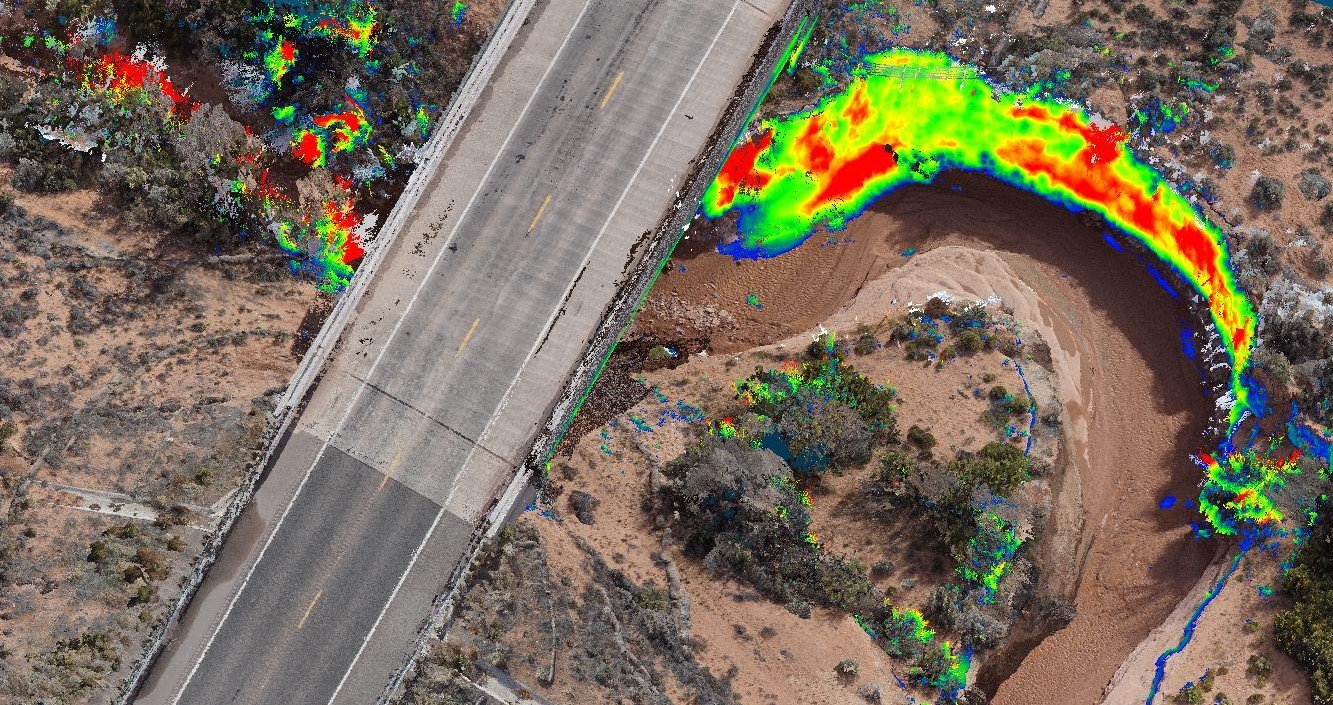 Overhead image of bridge at Laguna Creek with graphic overlay. The overlay displays changes from a previous survey through a color gradient. Several areas indicate differences of up to 3 feet.