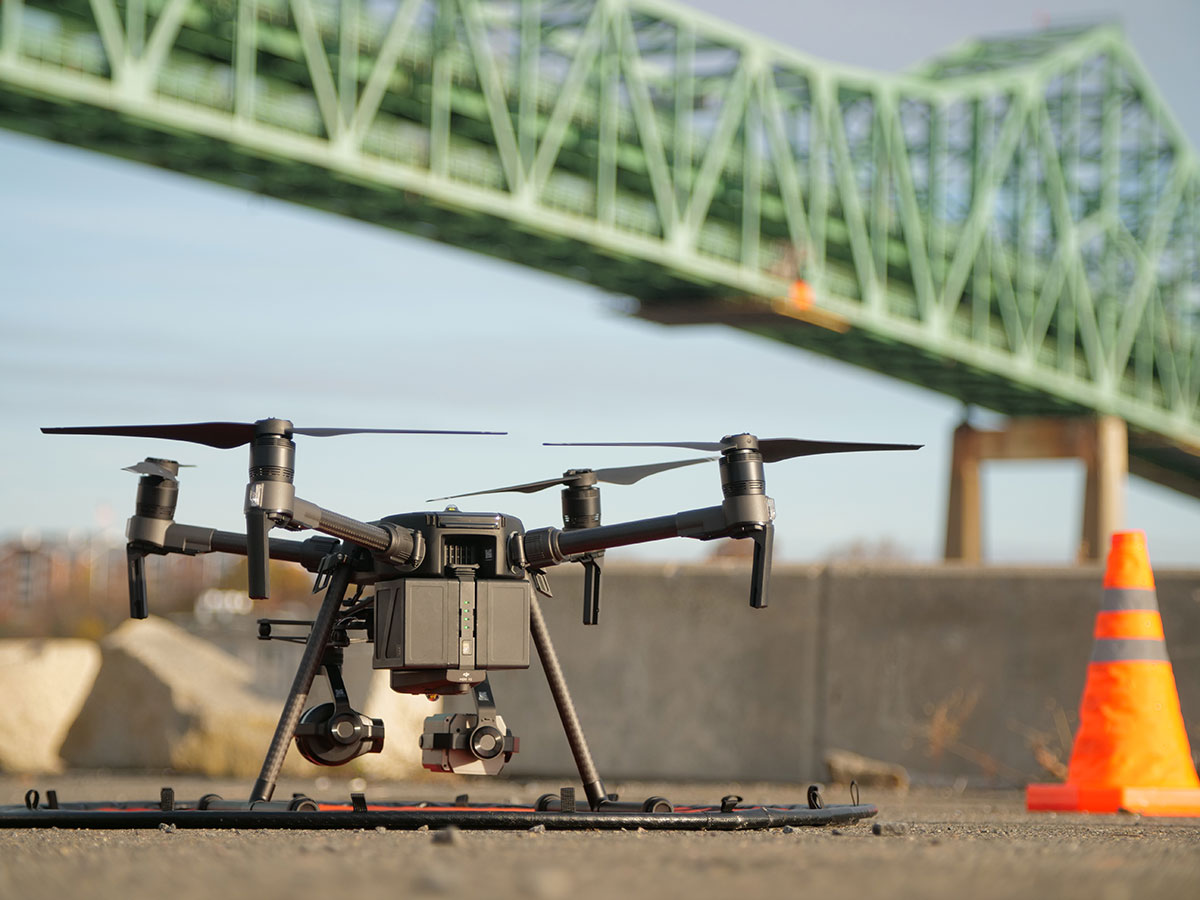 Close up image of UAS  with bridge in background.