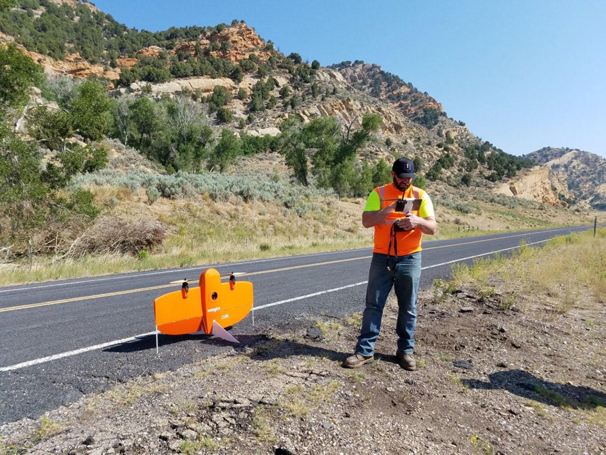 UDOT UAS operator standing next to roadway, preparing to launch UAS