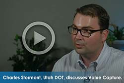 Close-up picture of man with play button overlayed on image. Text says, "Charles Stormont, Utah DOT, discusses Value Capture."