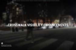 Blurred image of person crossing crosswalk at night with overlayed text stating, 'Crosswalk Visibility Enhancements.''