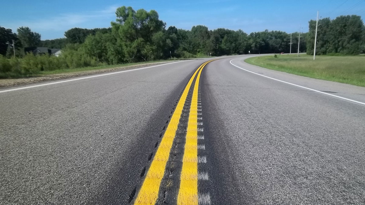 Two-lane rural road with center line rumble strips.