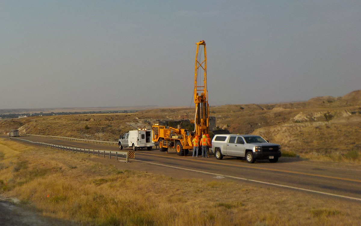 A drilling rig equipped with MWD sensors sits near an apparent sag in a roadway.